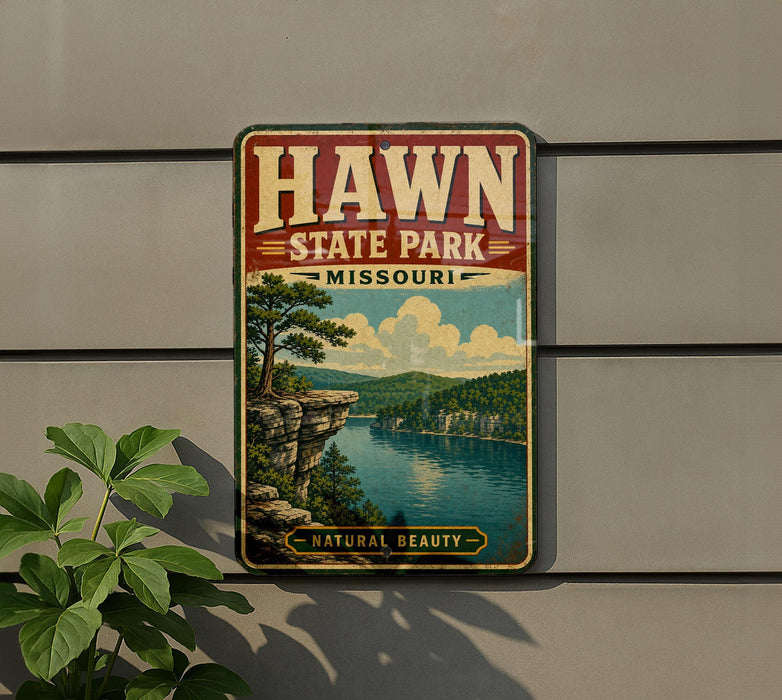 A vintage-style sign for Hawn State Park in Missouri, featuring a scenic landscape with a lake, mountains, and trees.
