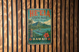 A vintage-style metal sign for He'eia State Park in Hawaii, featuring a tropical landscape with palm trees, mountains, and a body of water.