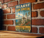 A vintage-style sign for Hearst San Simeon State Park, featuring a scenic illustration of the park's architecture and surrounding landscape.