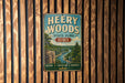 A vintage-style metal sign for Heery Woods State Park in Iowa, featuring a scenic landscape with a river and trees.