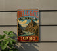 A vintage metal sign for Hells Gate State Park in Idaho, featuring a scenic mountain landscape with a river flowing through it.