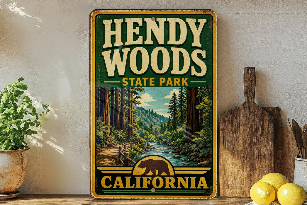 A vintage-style sign for Hendy Woods State Park in California, featuring a scenic illustration of a forest and a river.