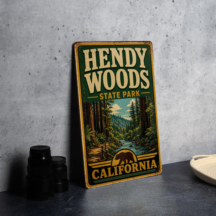 A vintage-style sign for Hendy Woods State Park in California, featuring a scenic illustration of a forest and a river.