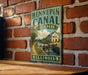 A vintage-style metal sign for Hennepin Canal State Park in Illinois, featuring a scenic illustration of a canal and a small building.
