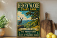 A vintage-style sign for Henry W. Coe State Park, featuring a scenic mountain landscape with a deer in the foreground.