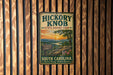 A vintage metal sign for Hickory Knob State Resort Park in South Carolina, featuring a scenic landscape with mountains, trees, and a sunset.