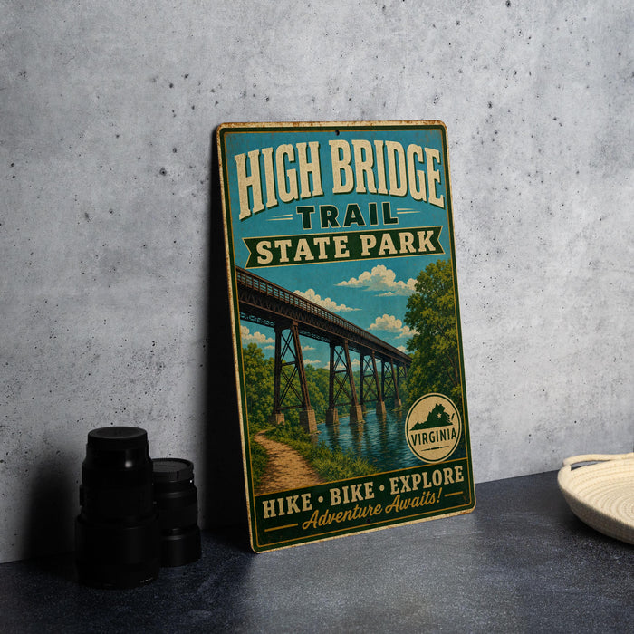 A vintage-style metal sign for High Bridge Trail State Park, featuring a bridge and a scenic landscape, is displayed on a gray concrete surface.