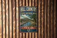 A vintage-style metal sign for the Hill Country State Natural Area in Texas, featuring a scenic landscape with a river and mountains.