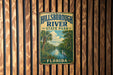 A vintage metal sign for Hillsborough River State Park in Florida, featuring a palm tree and a bird, is displayed on a wooden wall.