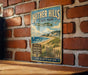 A vintage-style metal sign for Hitter Hills State Park, mounted on a brick wall.