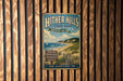 A vintage metal sign for Hither Hills State Park, Montauk, New York, mounted on a wooden wall.