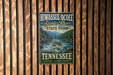 A vintage-style metal sign for Hiwasseocoeate Scenic River State Park in Tennessee, featuring a river scene with people rafting.