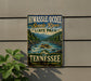 A vintage-style sign for Hiwassee/Ocee Scenic River State Park, featuring a river scene with people rafting and mountains in the background.