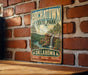 A vintage-style metal sign for HochatOWN State Park in Oklahoma, featuring a scenic landscape with a waterfall and pine trees.