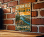 A vintage-style metal sign for Hoffman Hills State Recreation Area in Wisconsin, featuring a scenic landscape with a sunset over a lake.