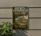 A vintage-style metal sign for Hofwyll Broadfield Plantation State Park in Georgia, featuring an illustration of a historic plantation house surrounded by lush greenery.