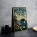 A vintage metal sign for Holbrook Island, Maine, featuring a scenic illustration of the island, a sailboat, and a moose.