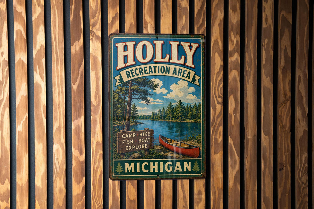 A vintage metal sign for the Holly Recreation Area in Michigan, featuring a scenic illustration of a lake, forest, and canoe.