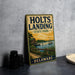 A vintage metal sign for Holts Landing State Park in Delaware, featuring an illustration of a dock and a boat on a lake.