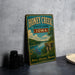 A vintage-style sign for Honey Creek State Park in Iowa, featuring a scenic landscape with a river, cliffs, and wildflowers.
