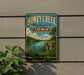 A vintage-style metal sign for Honey Creek State Park in Iowa, featuring a scenic landscape with a river, cliffs, and wildflowers.