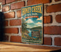 A vintage-style metal sign for Honey Creek State Park in Oklahoma, featuring a scenic landscape with a lake and mountains.