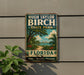 A vintage-style sign for Hugh Taylor Birch State Park in Florida, featuring a tropical landscape with palm trees and a path leading through the greenery.