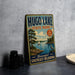 A vintage-style sign for Hugo Lake State Park, featuring a scenic illustration of a lake, trees, and a sailboat.