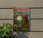 A vintage-style metal sign for Humboldt Redwoods State Park in California, featuring a scenic illustration of the park's iconic redwood trees and a river.