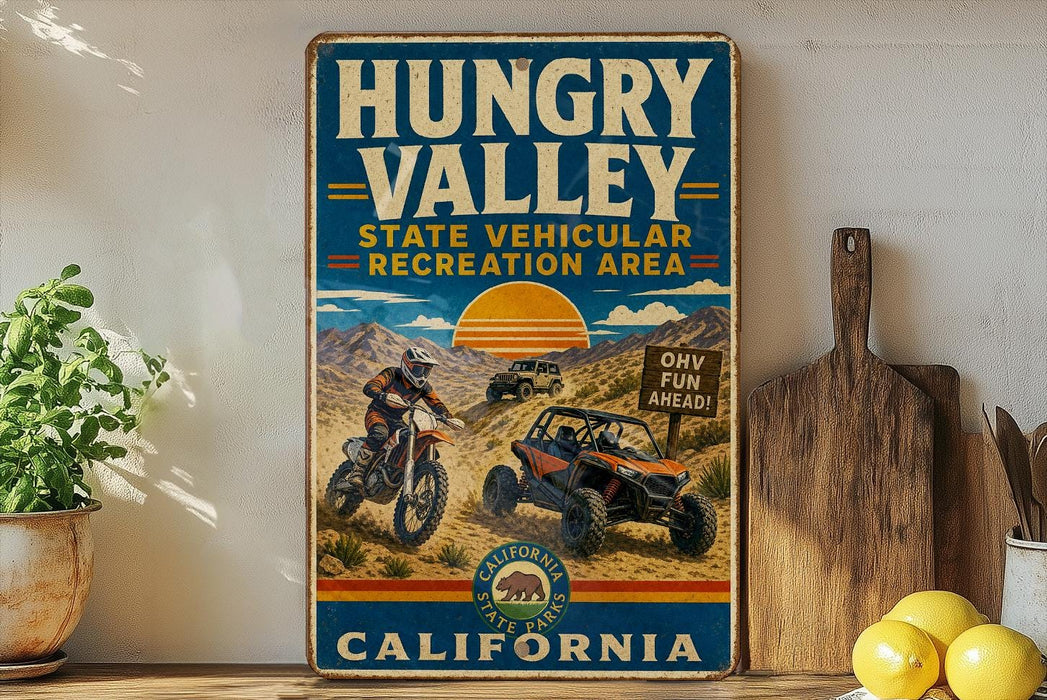 A vintage-style sign for the Hungry Valley State Vehicular Recreation Area in California, featuring an illustration of a person riding a dirt bike and a sign that says "OH VE H FUN AHEAD!"