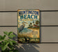 A vintage metal sign for Huntington Beach State Park, featuring a seagull and a lighthouse, is displayed on a wall.