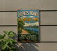 A vintage-style metal sign for Hunts Point Riverside Park in New York, featuring a scenic image of the park and its surroundings.