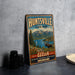 A vintage metal sign for Huntsville State Park in Utah, featuring a scenic landscape with mountains, a moose, and a lake.