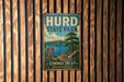 A vintage metal sign for Hurd State Park, featuring a scenic landscape with a lake, mountains, and pine trees.