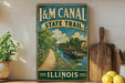 A vintage-style sign for the Illinois State Trail, featuring a scenic illustration of a canal and a bridge, with the text "I&M Canal State Trail" and "Illinois" below.