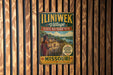A vintage metal sign for the Iliniwek Village State Historic Site in Missouri, featuring a colorful illustration of a Native American village.