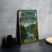 A vintage-style sign for Illinois River Forks State Park in Oregon, featuring a scenic illustration of a river surrounded by mountains and pine trees.