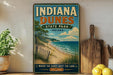 A vintage-style sign for Indiana Dunes State Park, featuring a beach scene with a lake in the background.