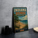 A vintage-style sign for Indiana Dunes State Park, featuring a scenic beach landscape with a lake and a cloudy sky.