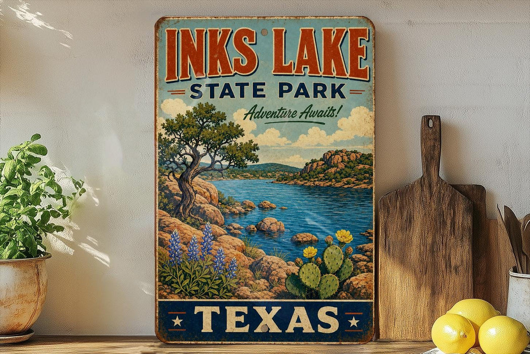 A vintage-style sign for Inks Lake State Park in Texas, featuring a scenic landscape with a lake, mountains, and desert.