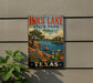 A vintage-style sign for Inks Lake State Park in Texas, featuring a scenic landscape with a lake, mountains, and cacti.