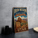 A vintage-style metal sign for the Iron Mission State Park Museum in Utah, featuring an illustration of the historic mission and its surroundings.
