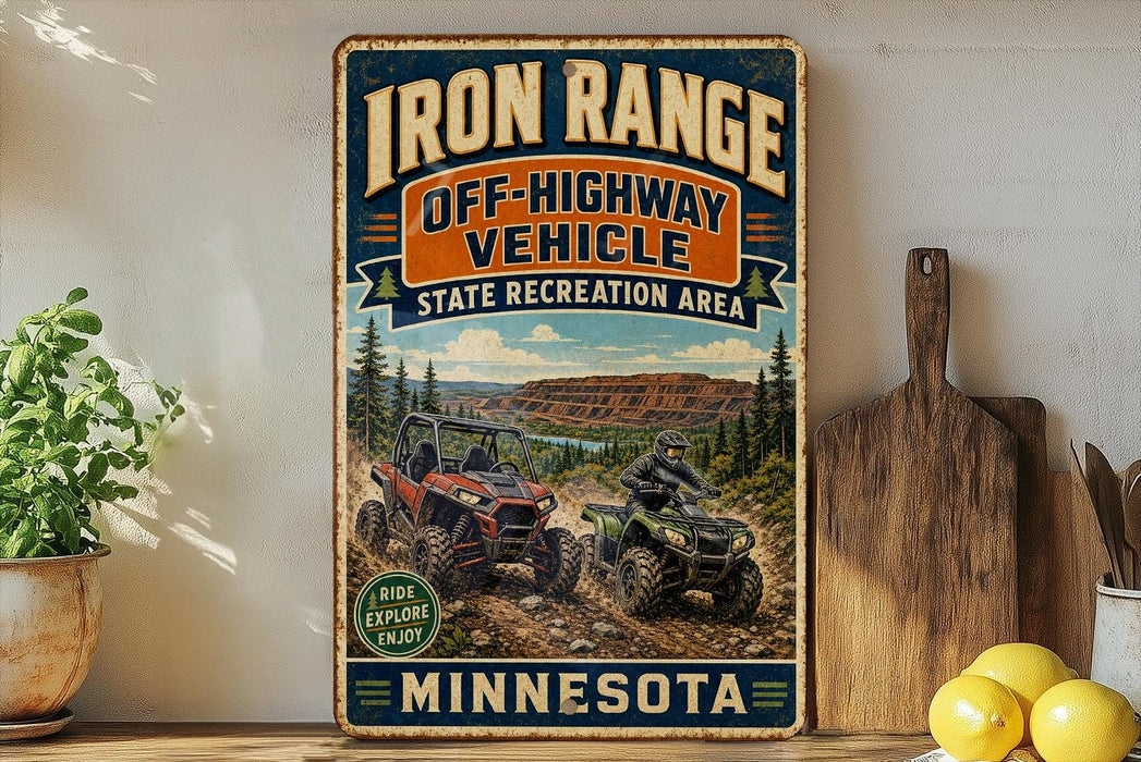 a vintage-style sign for the Iron Range Off-Highway Vehicle State Recreation Area in Minnesota, with illustrations of ATVs and a scenic landscape.