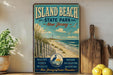 A vintage-style poster advertising Island Beach State Park in New Jersey, featuring a beach scene with a lighthouse and birds in flight.