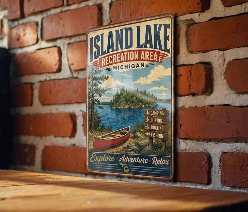 A vintage-style metal sign for the Island Lake Recreation Area in Michigan, featuring a scenic image of a lake, canoe, and surrounding forest.