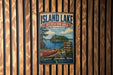 A vintage metal sign for Island Lake Recreation Area in Michigan, featuring a red canoe and a scenic landscape.