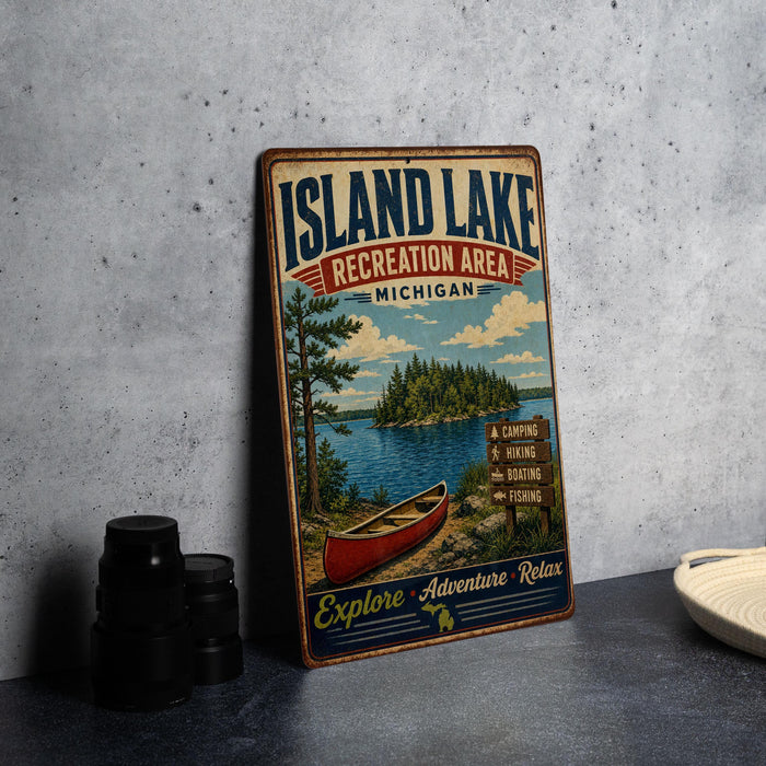 A vintage-style metal sign for the Island Lake Recreation Area in Michigan, featuring a canoe and a scenic landscape.