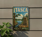 A vintage-style metal sign for Itasca State Park in Minnesota, featuring a scenic landscape with a river, trees, and a monument.