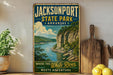 A vintage-style sign for Jacksonport State Park in Arkansas, featuring a scenic image of a river and cliffs, with the text "Where the White River Meets Adventure" and "Arkansas" written on it.