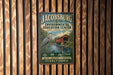 A vintage-style metal sign for the Jacobburg Environmental Education Center, featuring a bird and a bridge, is displayed on a wooden wall.